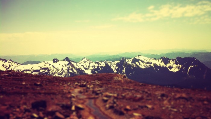Snow-capped mountains under a hazy sky