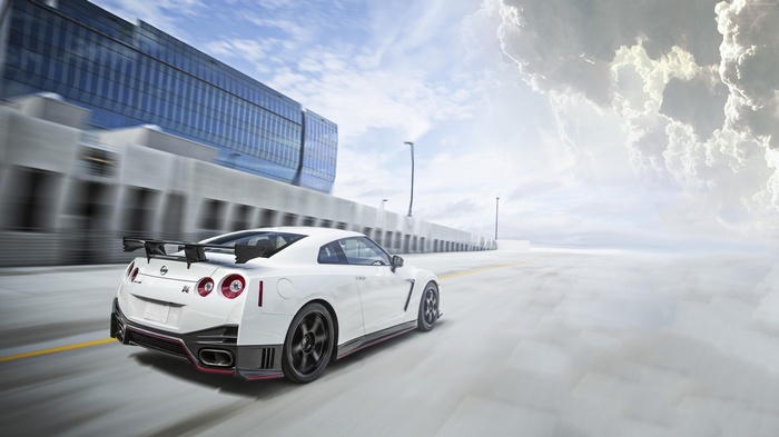 White Nissan GT-R Nismo driving on a highway