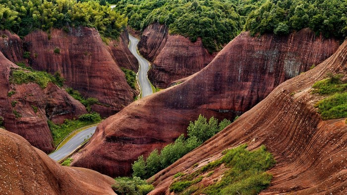 Winding Road Through Red Rock Canyon and Green Forest