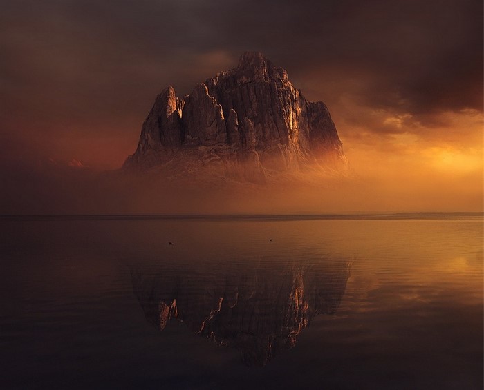 Mountain reflected in water at sunset