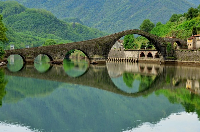 Devil's Bridge over a river with green hills