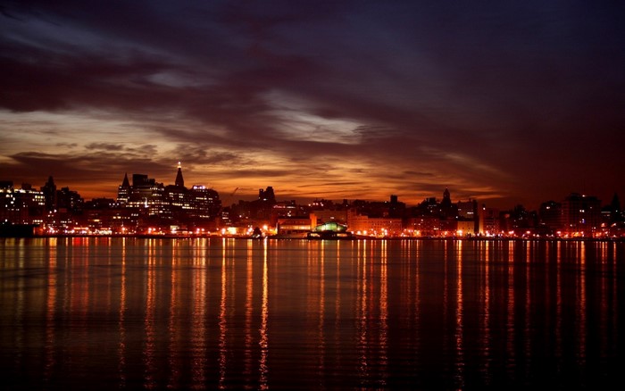 City skyline at dusk with water reflections