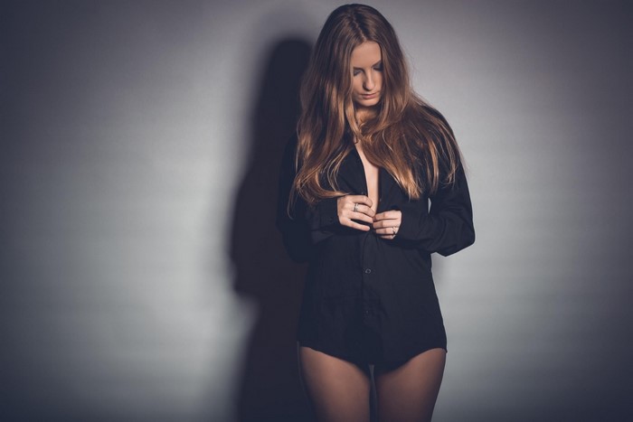 Woman in black shirt with long brown hair
