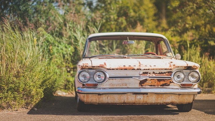 Rusty vintage Chevrolet sedan parked outdoors