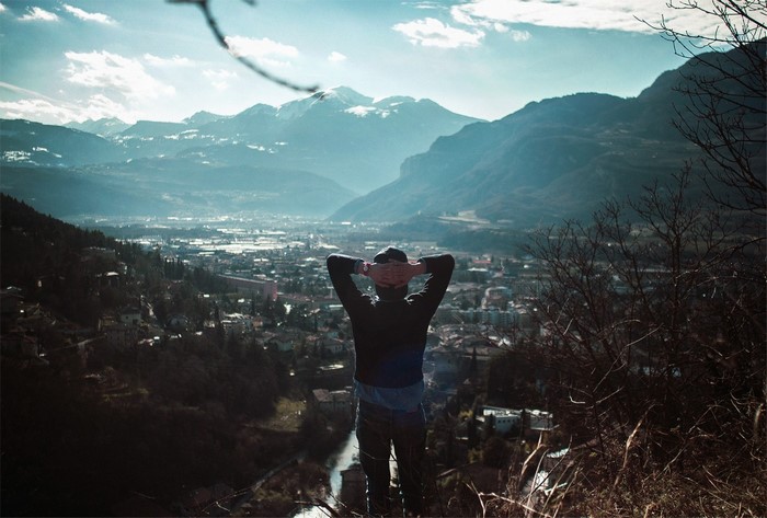Man overlooking a valley and mountains