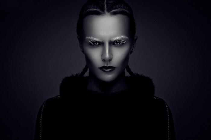 Monochrome portrait of a woman with braided hair and white eyebrows