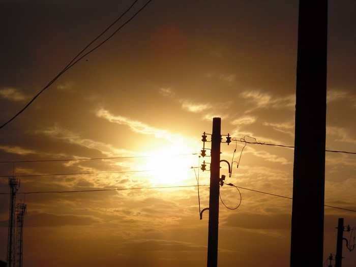 Sunset with power lines and cell towers
