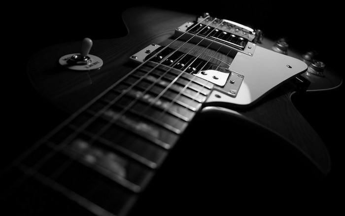 Monochrome close-up of an electric guitar