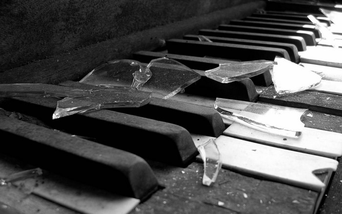 Broken piano keys with shattered glass