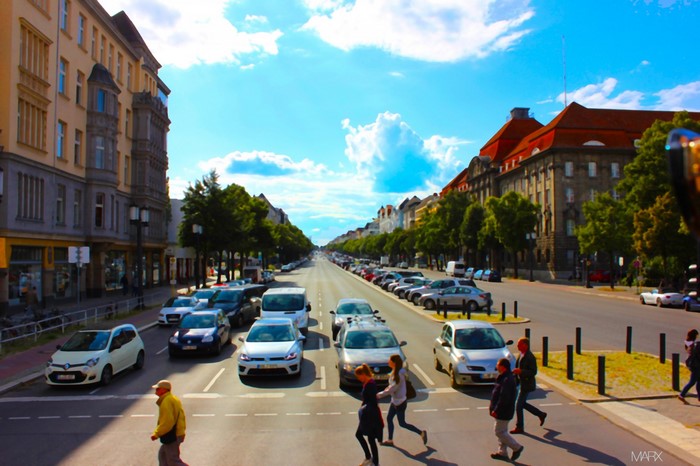 People crossing a busy street in a European city