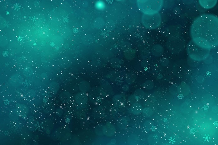 Sparkling snowflakes and bokeh in a teal nebula