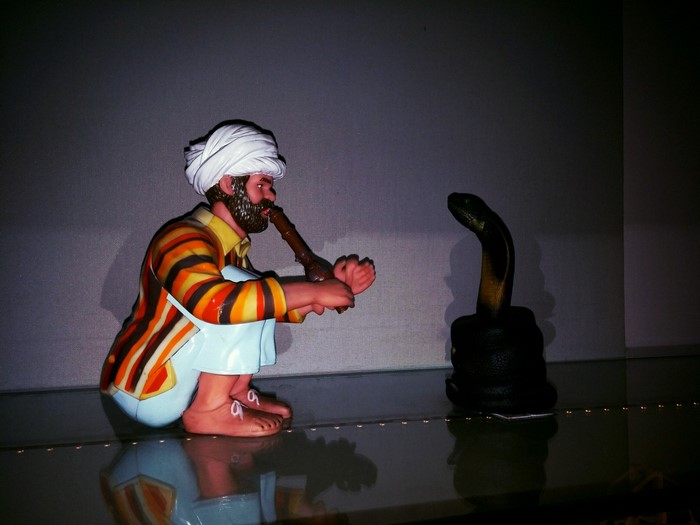 Snake charmer with cobra statue