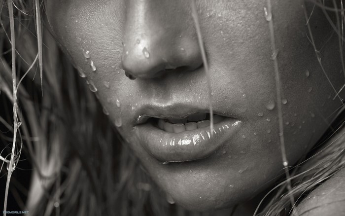 Close up of a woman's face with water droplets
