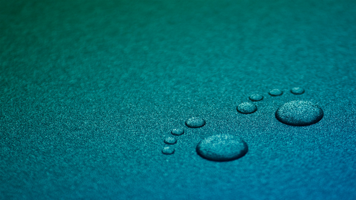 Water drops forming a footprint on a textured surface