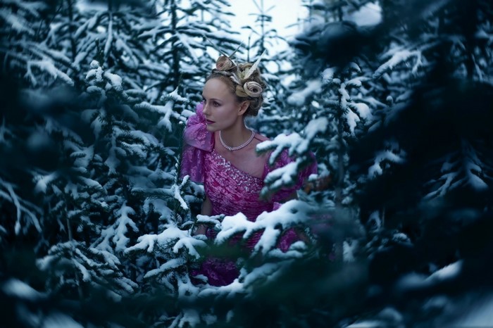 Woman in pink dress in snowy forest