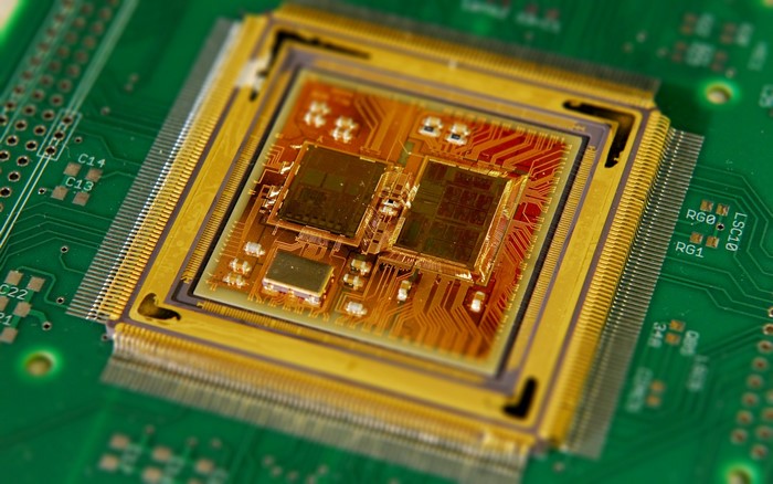 Close-up of a complex microchip on a green circuit board