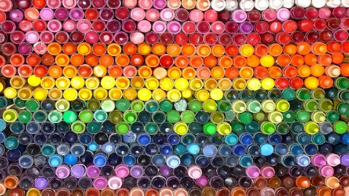 Colorful crayons arranged in a rainbow pattern