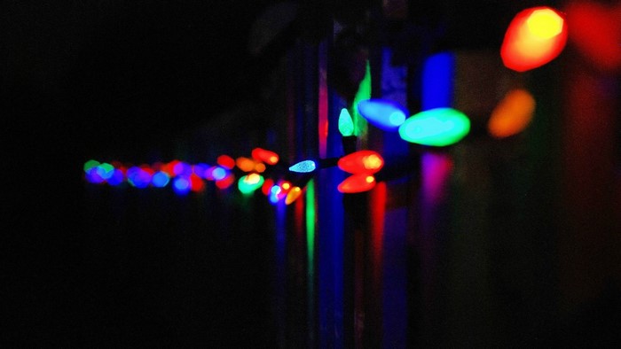 String of colorful bokeh Christmas lights at night