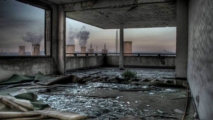 Abandoned building overlooking industrial complex