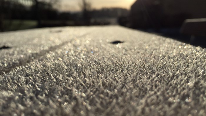 Close-up of frost on a surface in morning sunlight