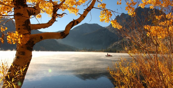 Autumn lake with mist and mountains