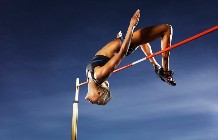 Female Athlete Performing High Jump in Sports Arena