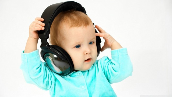 Baby wearing large black headphones