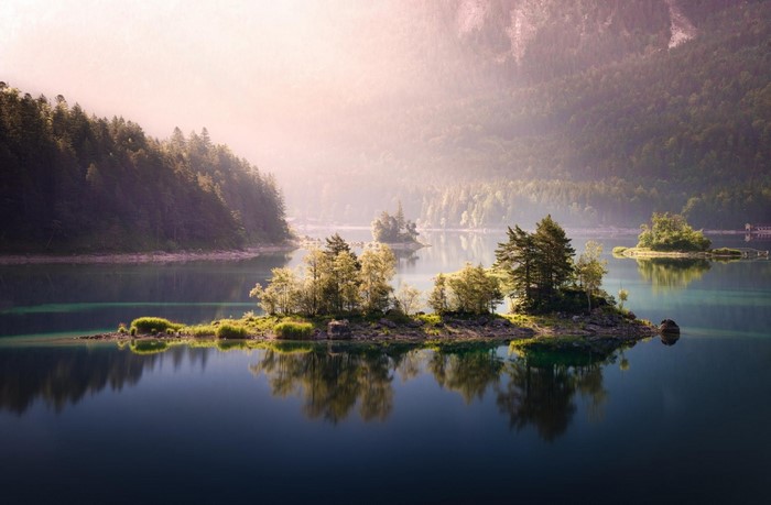 Islands in a misty lake at sunrise