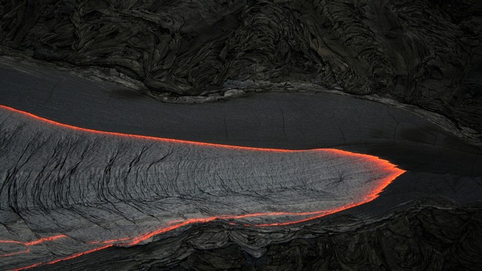 Flowing lava in a volcanic landscape