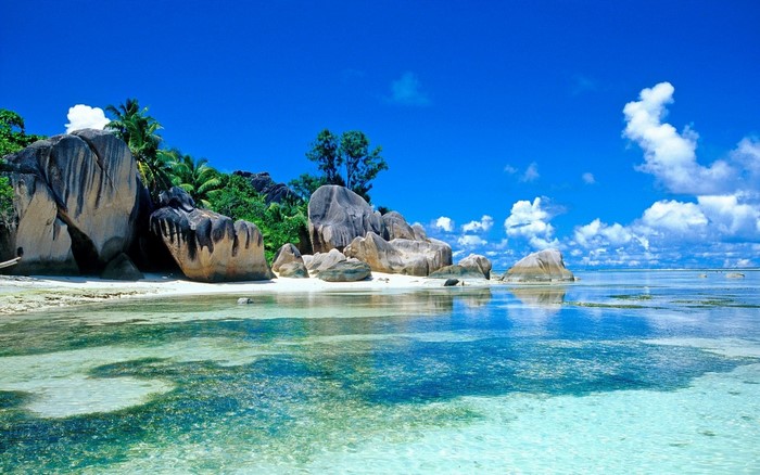 Tropical beach with granite boulders and clear turquoise water