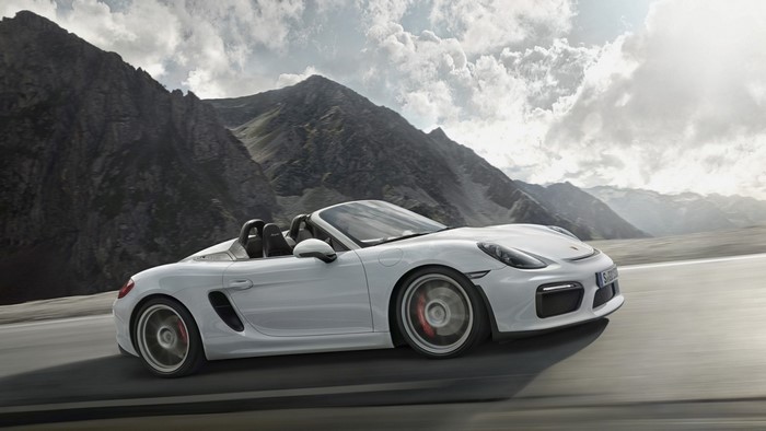 White Porsche Boxster driving on a mountain road