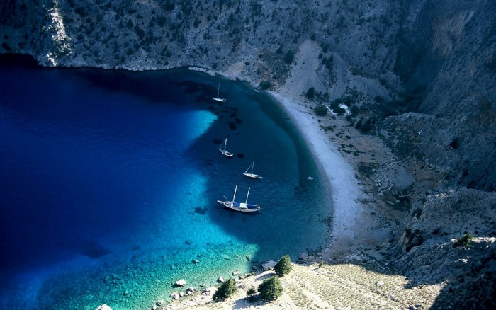 Aerial view of a secluded bay with sailboats