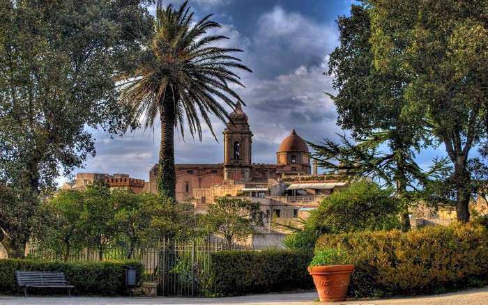 Garden with a church and palm tree