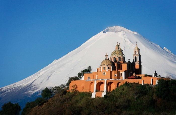 Church on a hill with Pico de Orizaba volcano in the background