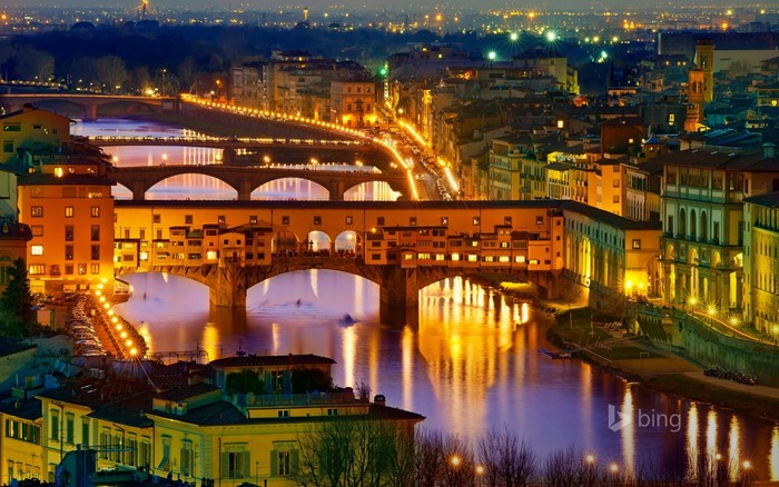 Ponte Vecchio bridge over Arno River in Florence at night
