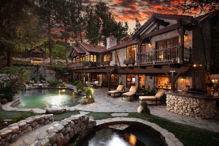 Luxury mountain estate with pool and hot tub at sunset