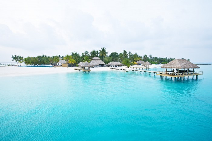 Tropical island resort with overwater bungalows and turquoise water