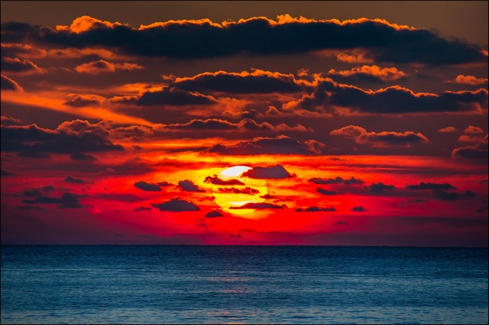 Sunset over the ocean with dramatic clouds