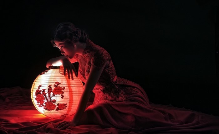 Woman in red dress with lantern