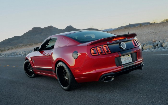 Red Ford Shelby GT500 Mustang parked on a road
