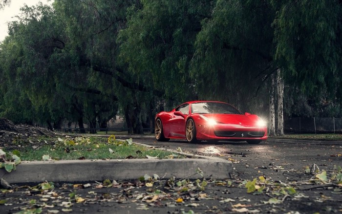 Red Ferrari 458 Italia parked on a wet road