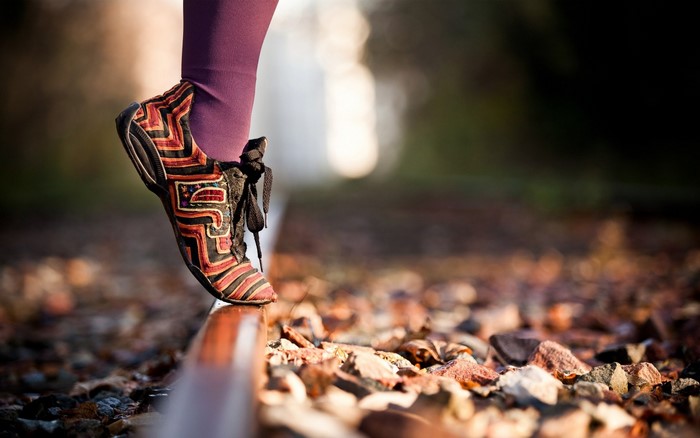 Person walking on railroad tracks