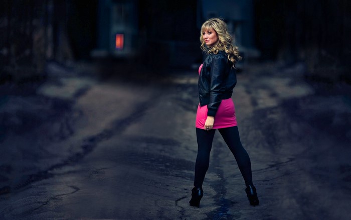 Woman in pink dress and leather jacket