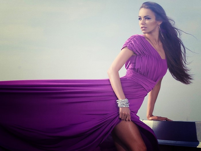 Woman in a purple dress posing outdoors
