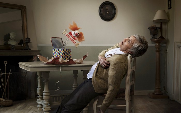 Elderly woman startled by jack-in-the-box