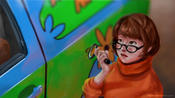 Velma Dinkley from Scooby Doo holding a magnifying glass