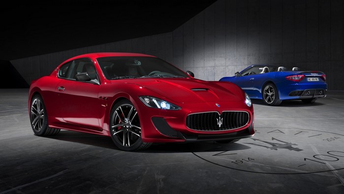 Red and blue Maserati sports cars in a studio