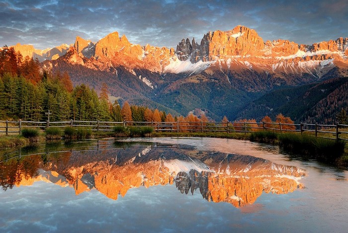 Sunset Reflection over Dolomites Mountains and Lake