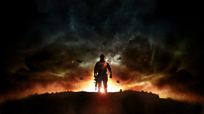 Soldier standing on a hill with aircraft in the sky