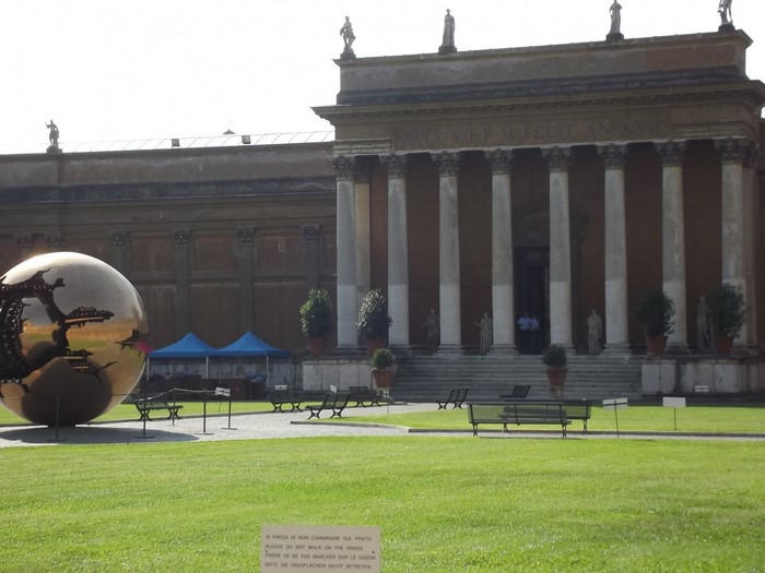 Sphere sculpture in front of museum with columns